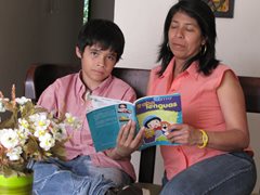 A boy reading with his SOS mother  (photo: SOS archives)