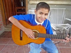 Boy playing the guitar - photo: SOS archives