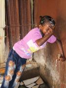 A little girl in our care at the water tap (photo: SOS archives)