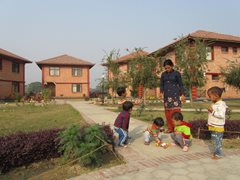 An SOS family in front of family homes (photo: SOS archives).