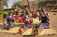 Children in our care enjoying their healthy breakfast in the garden (photo: SOS archives).