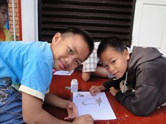 Two boys doing their homework together (photo: SOS archives).